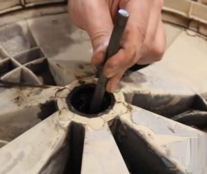 Hvordan fjerne et fast lager fra en vaskemaskintrommel?